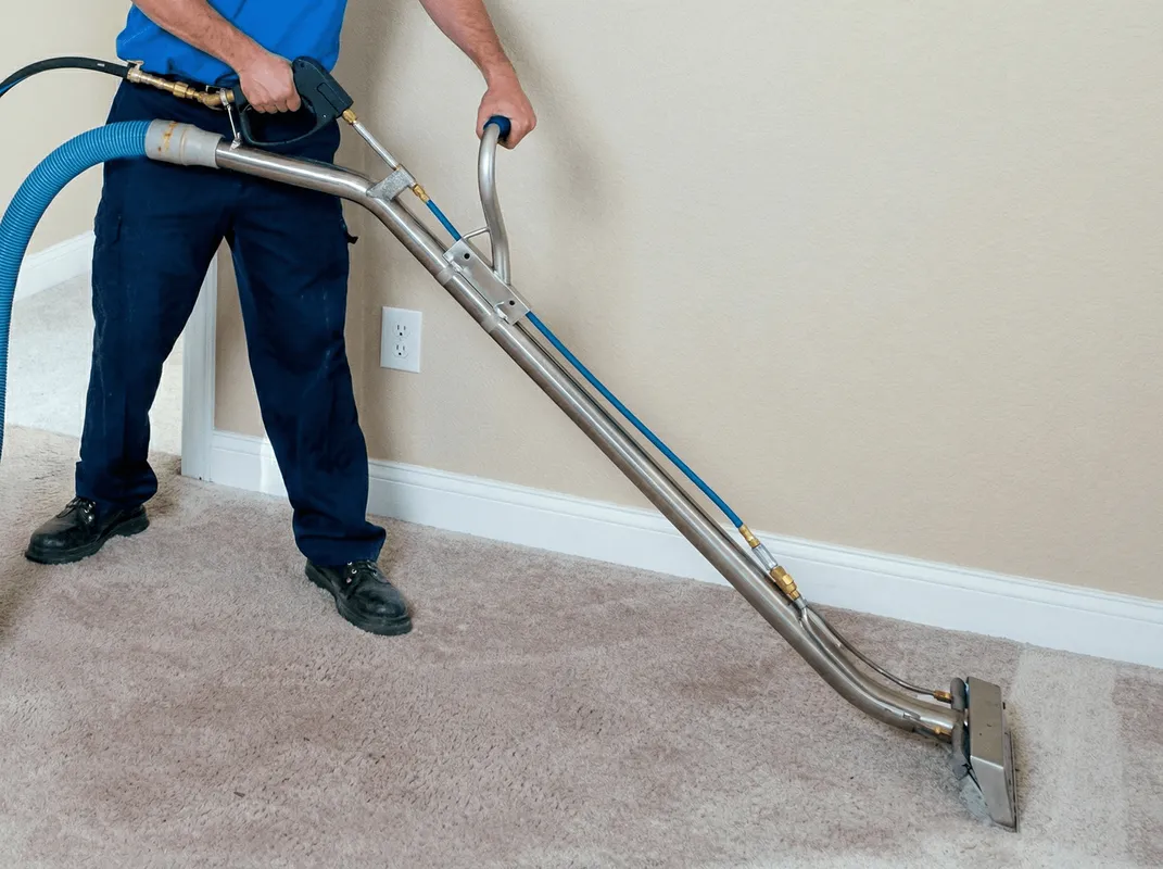 Professional operating a liquid removal machine on a carpeted floor in Ogden, UT